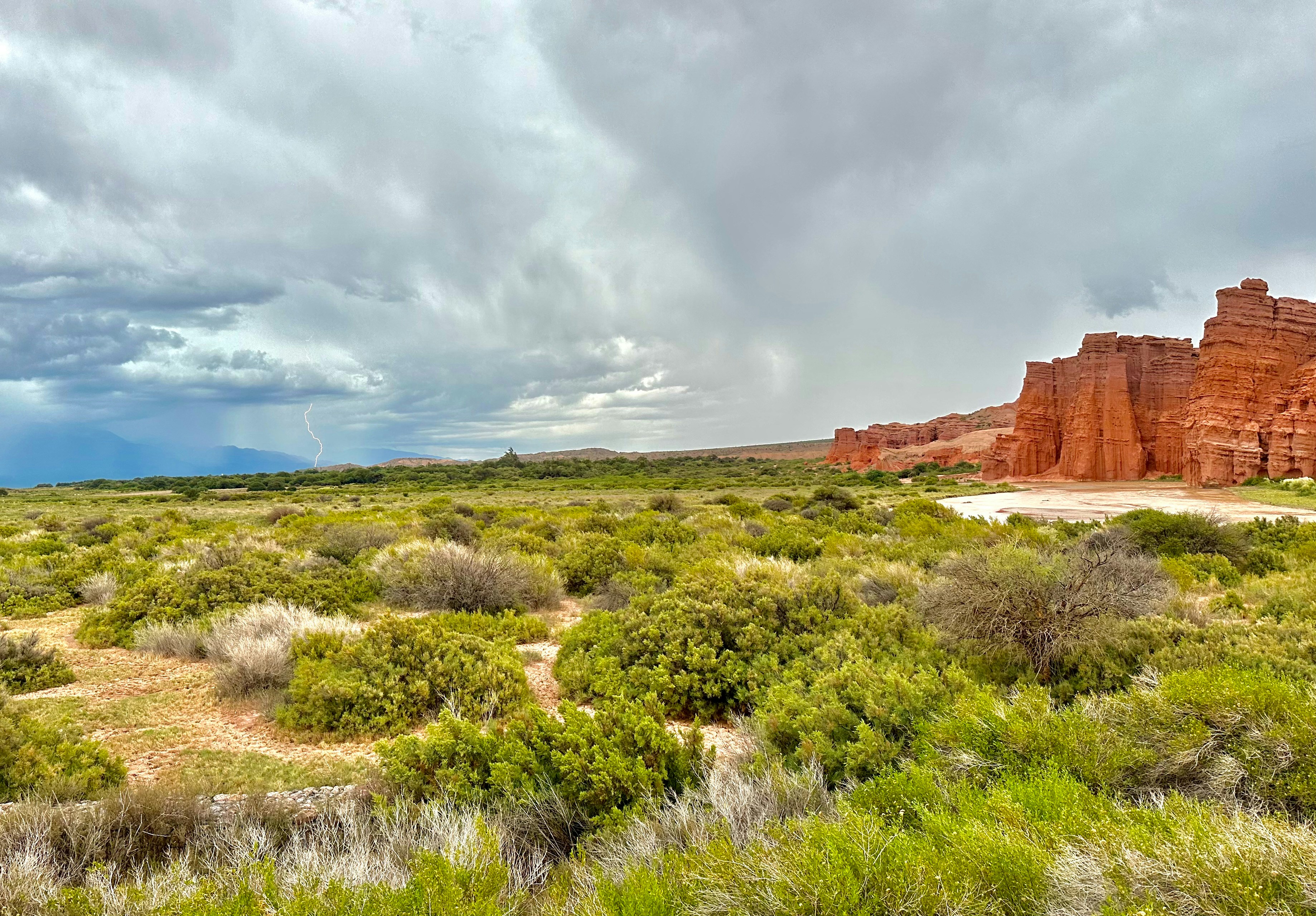a scenic view of a desert landscape with rocks and trees
