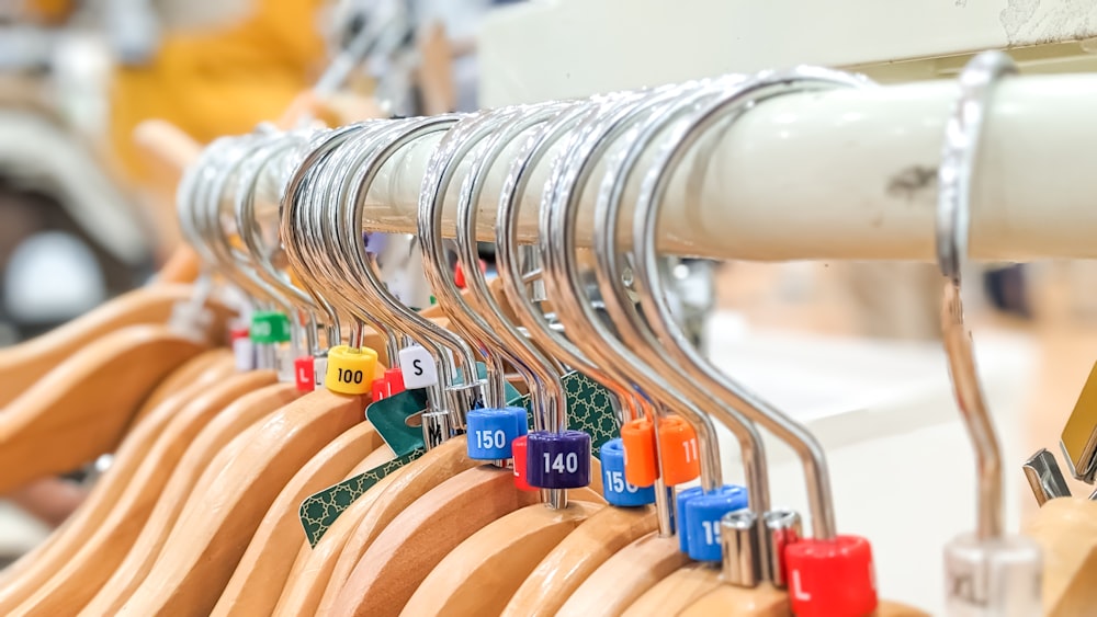 a row of wooden clothes hangers with numbers on them