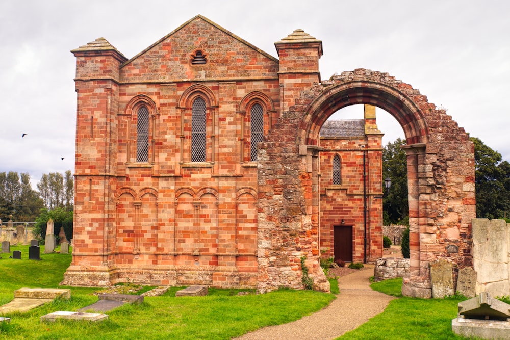 an old brick church with a stone archway