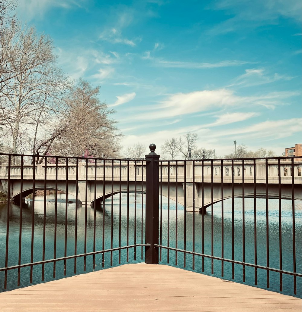 a bridge over a body of water with a bridge in the background