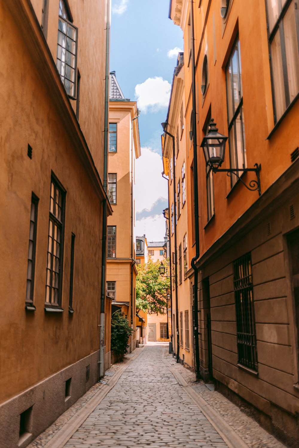 a narrow cobblestone street in a european city