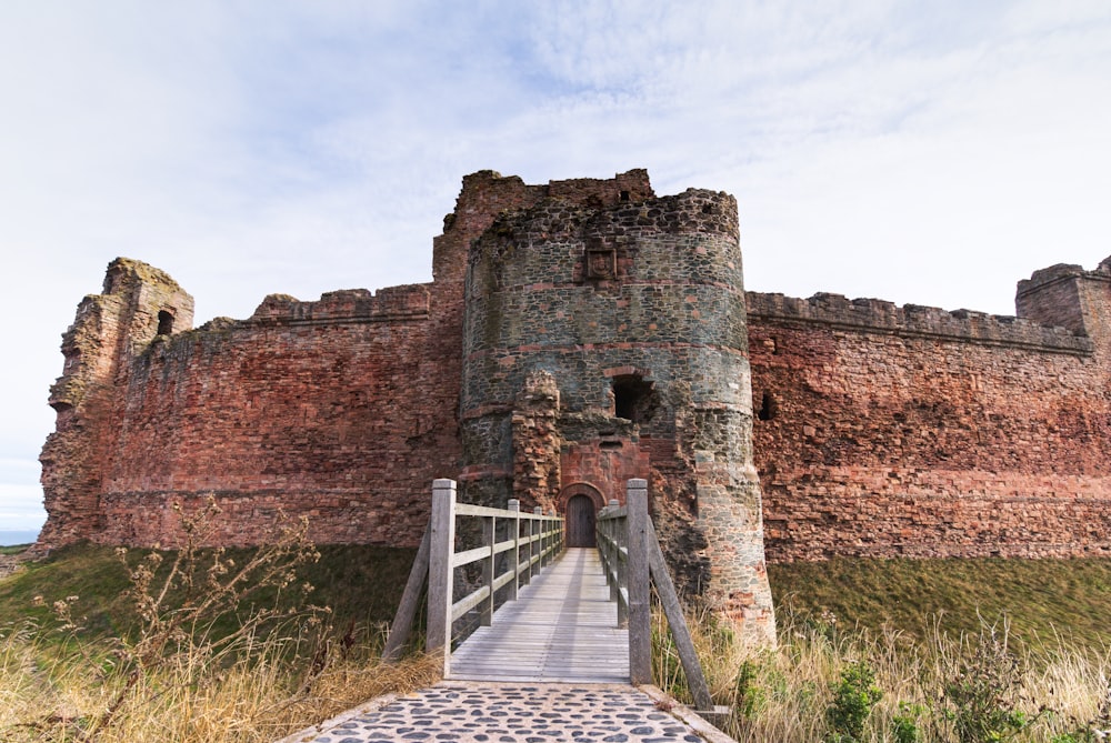 a wooden walkway leading to a castle like structure