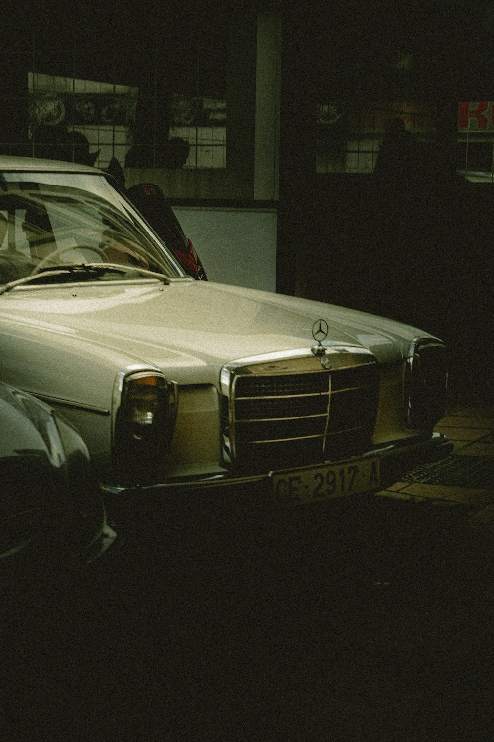 a white car parked in a parking lot next to a building