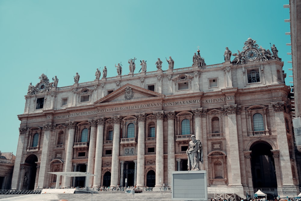 a large building with a statue in front of it