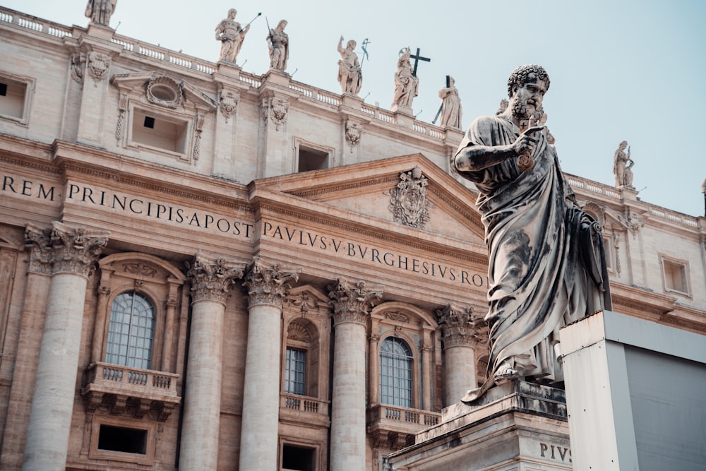 a statue of a woman in front of a building