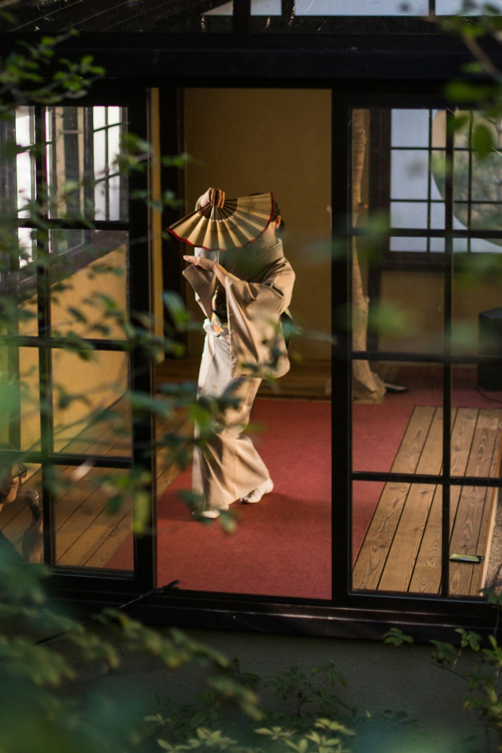 a woman in a kimono walking into a room