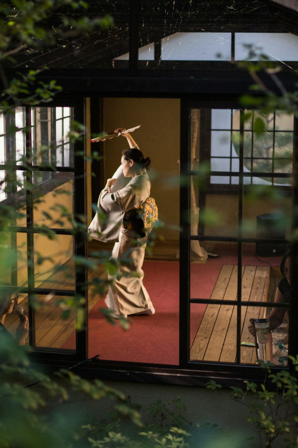 a woman in a kimono standing in a doorway