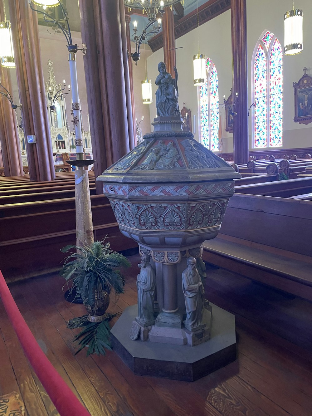 a church with pews and stained glass windows