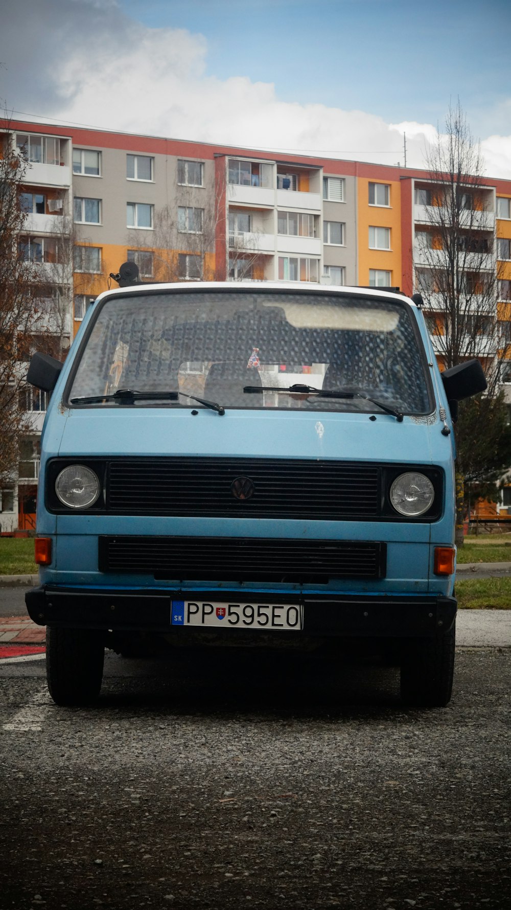 a blue van parked in front of a building