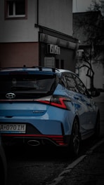a blue car parked on the side of the road