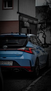 a blue car parked on the side of the road