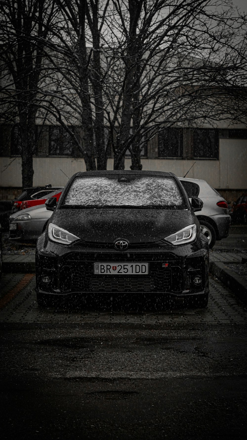 a car is parked in a parking lot in the snow