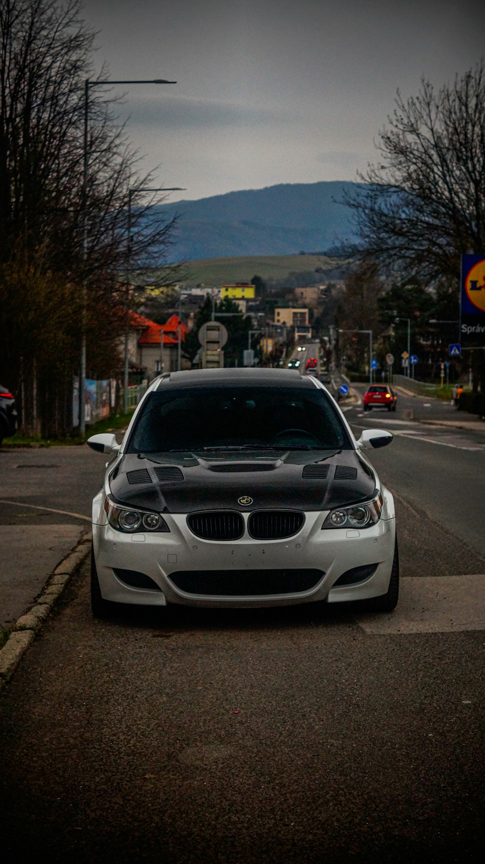 a white car parked on the side of a road