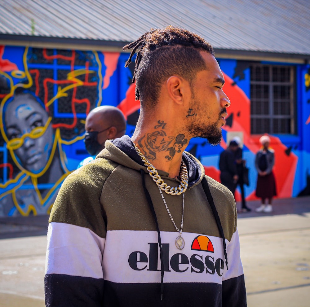 a man with a tattoo standing in front of a building