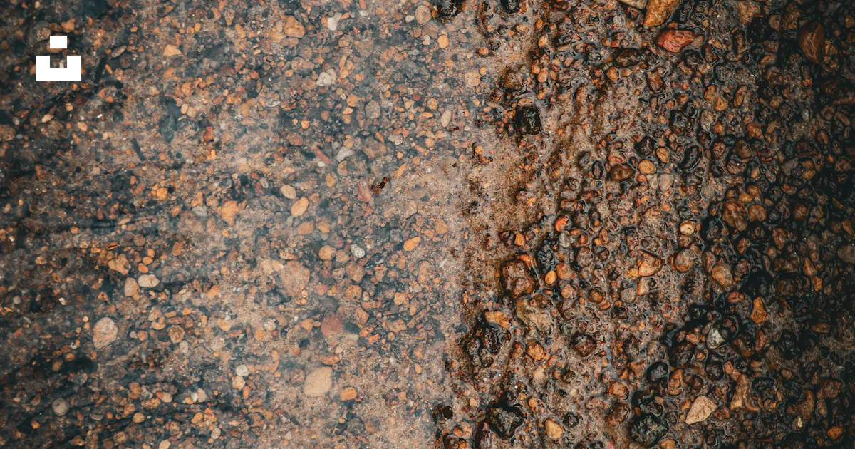 A close up of dirt and rocks with a small amount of dirt on the ground ...