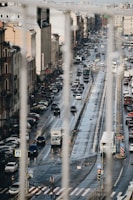 a city street filled with lots of traffic next to tall buildings