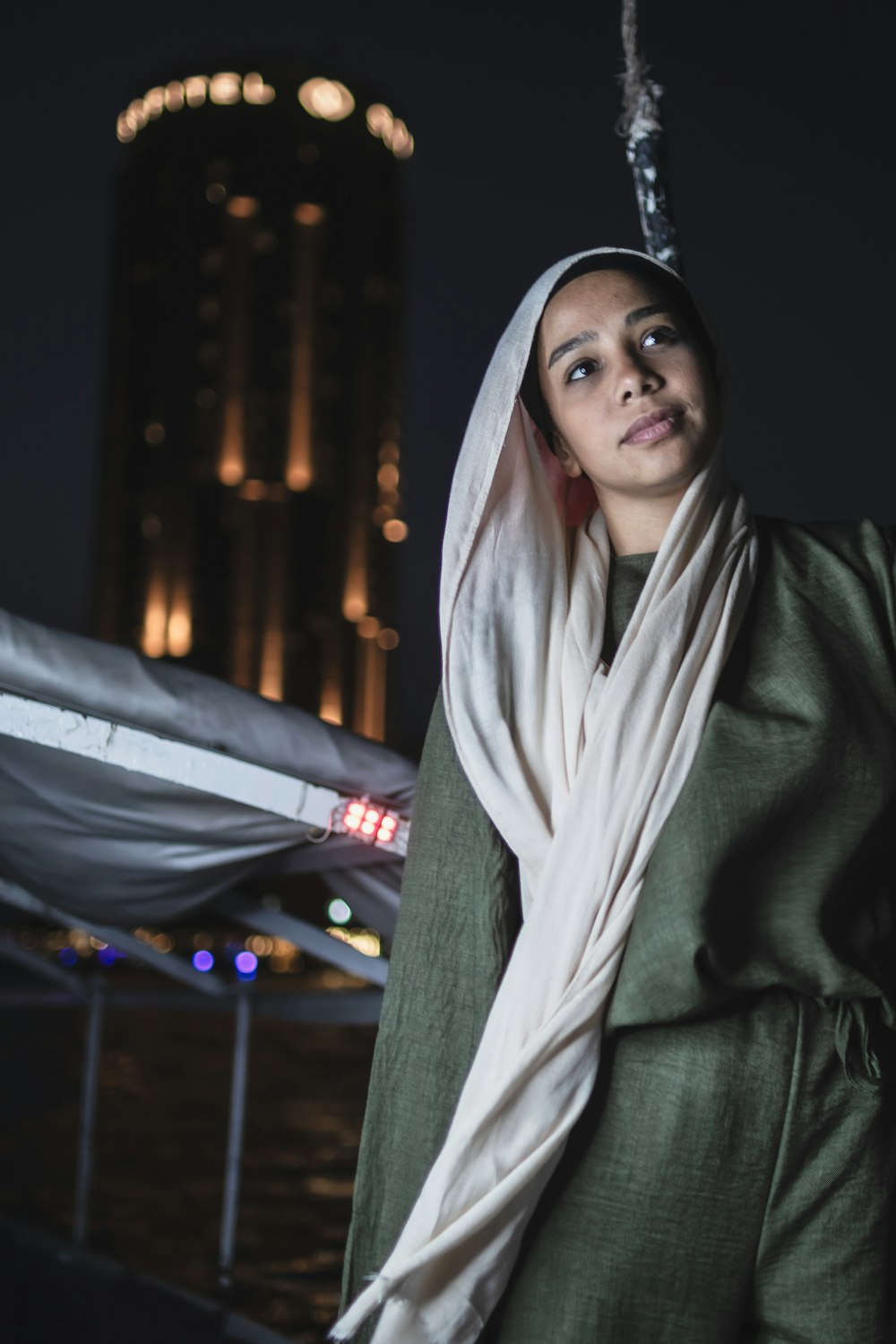 a woman in a green jacket and a white scarf