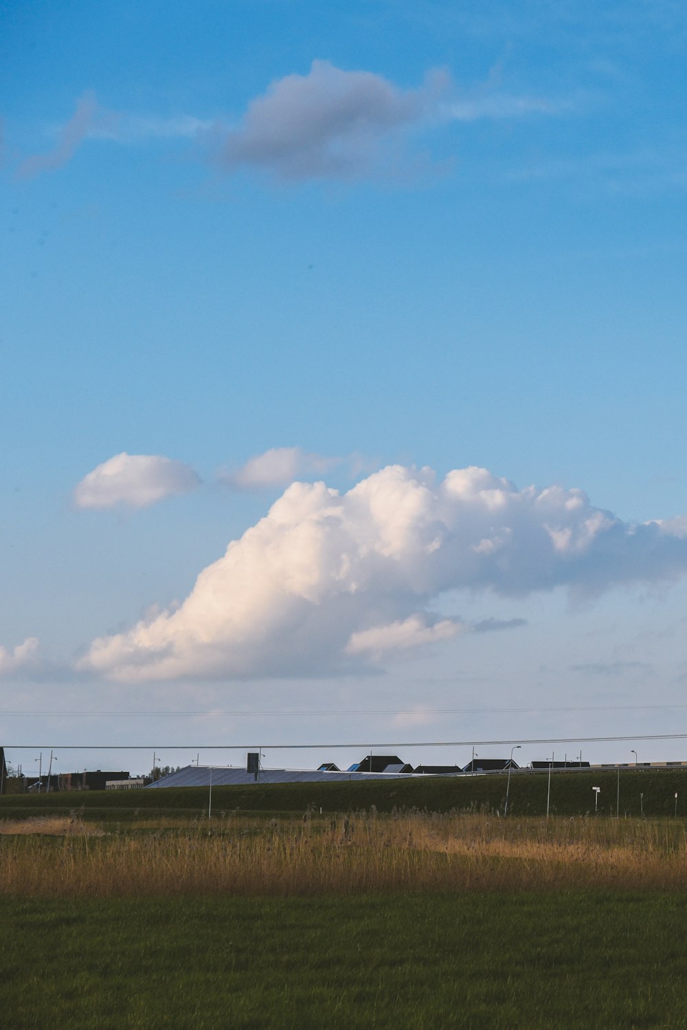 a plane flying in the sky over a field