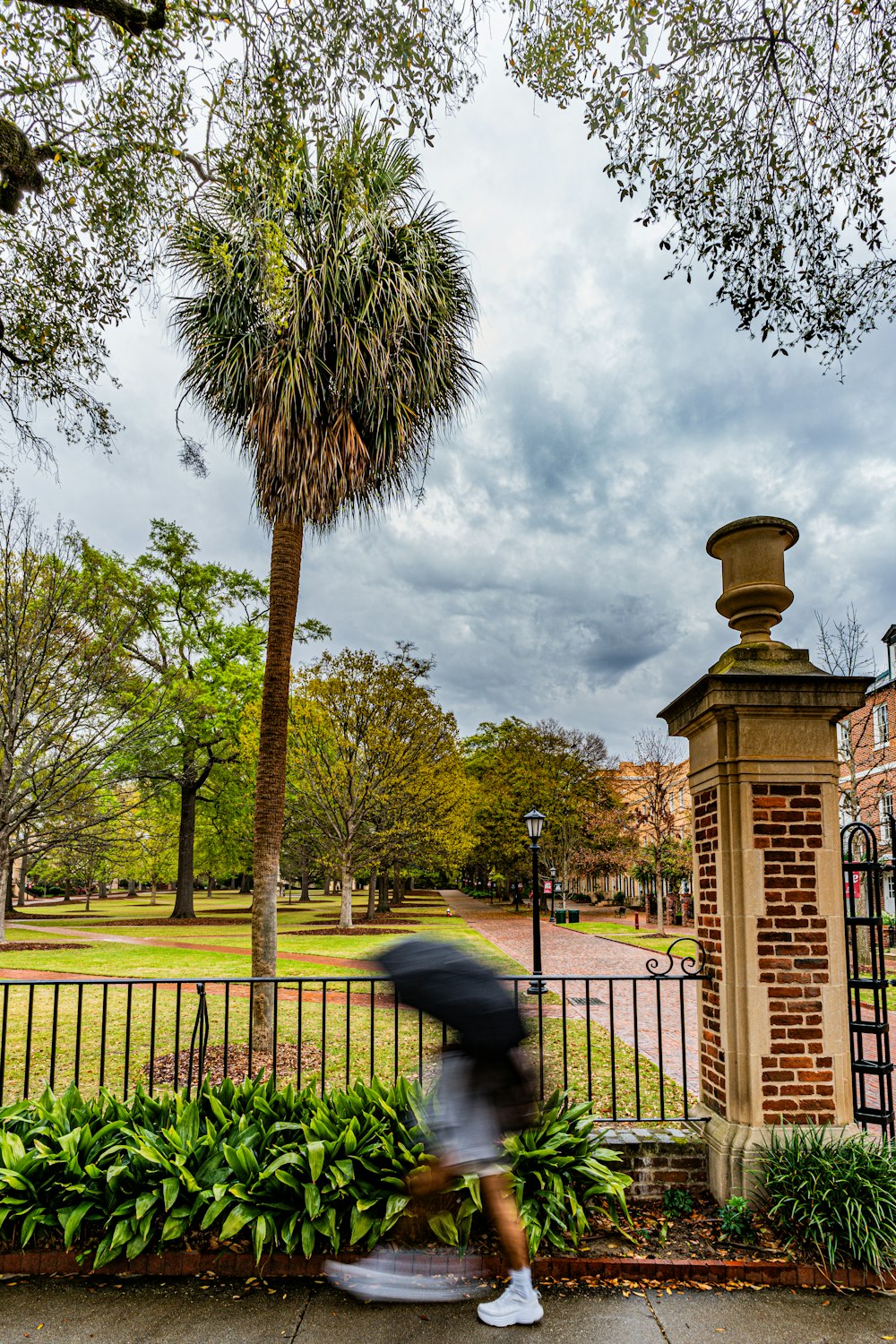 a person walking down a sidewalk with an umbrella