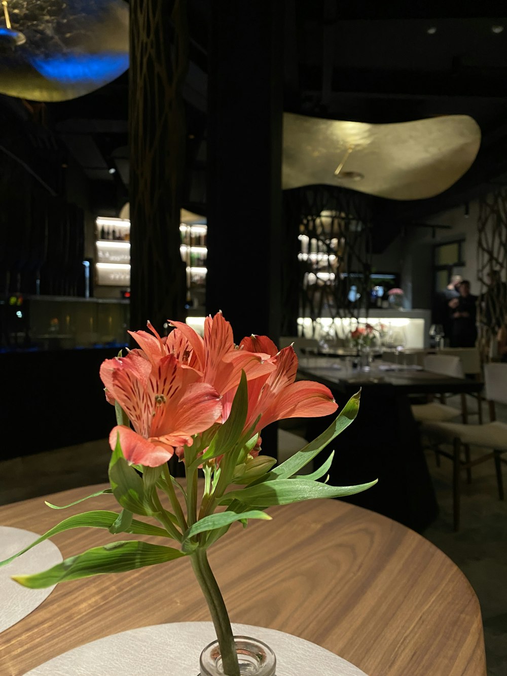 a vase filled with flowers on top of a wooden table