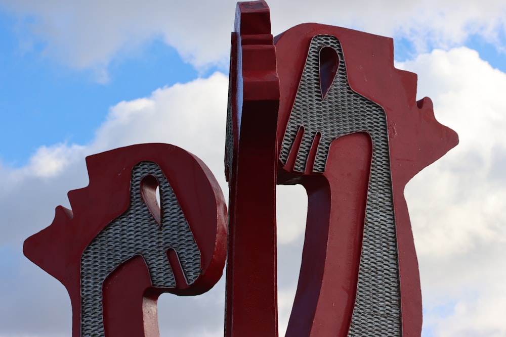 a large metal sculpture with a red and black design