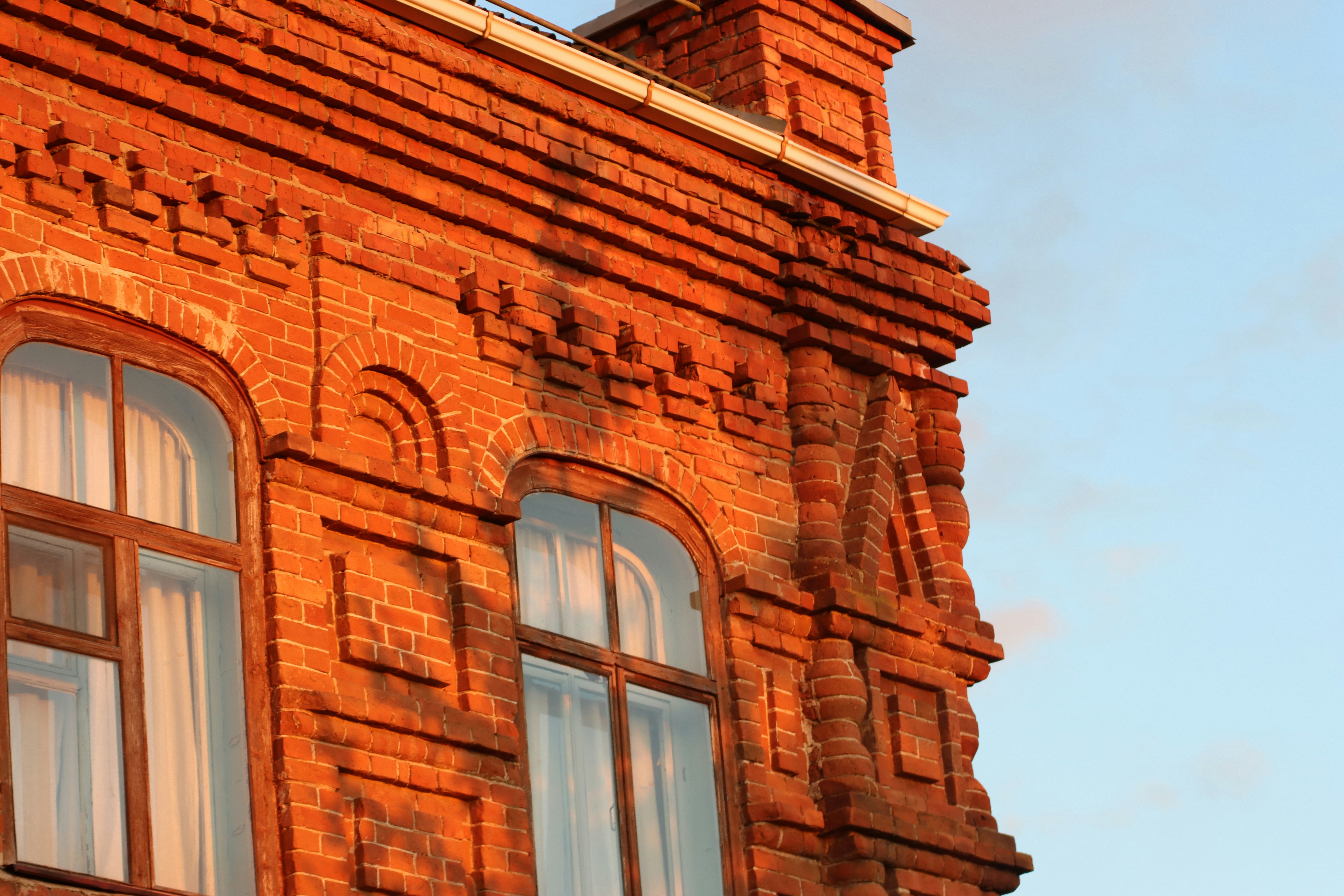 a brick building with two windows and a clock tower