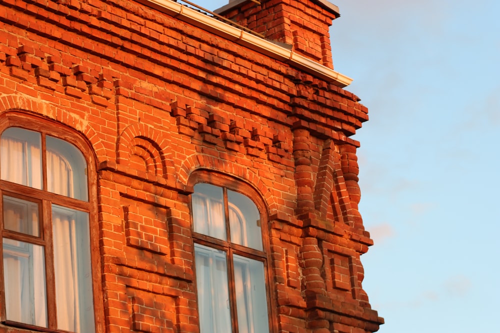 a brick building with two windows and a clock tower