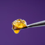 a drop of liquid is being held by a needle