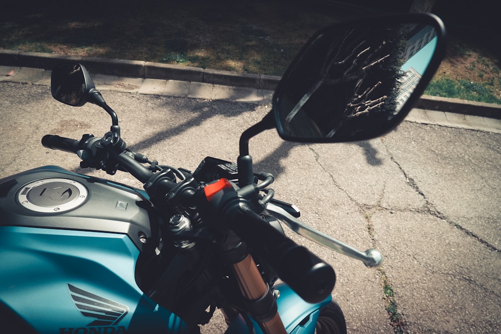 a blue motorcycle parked on the side of the road