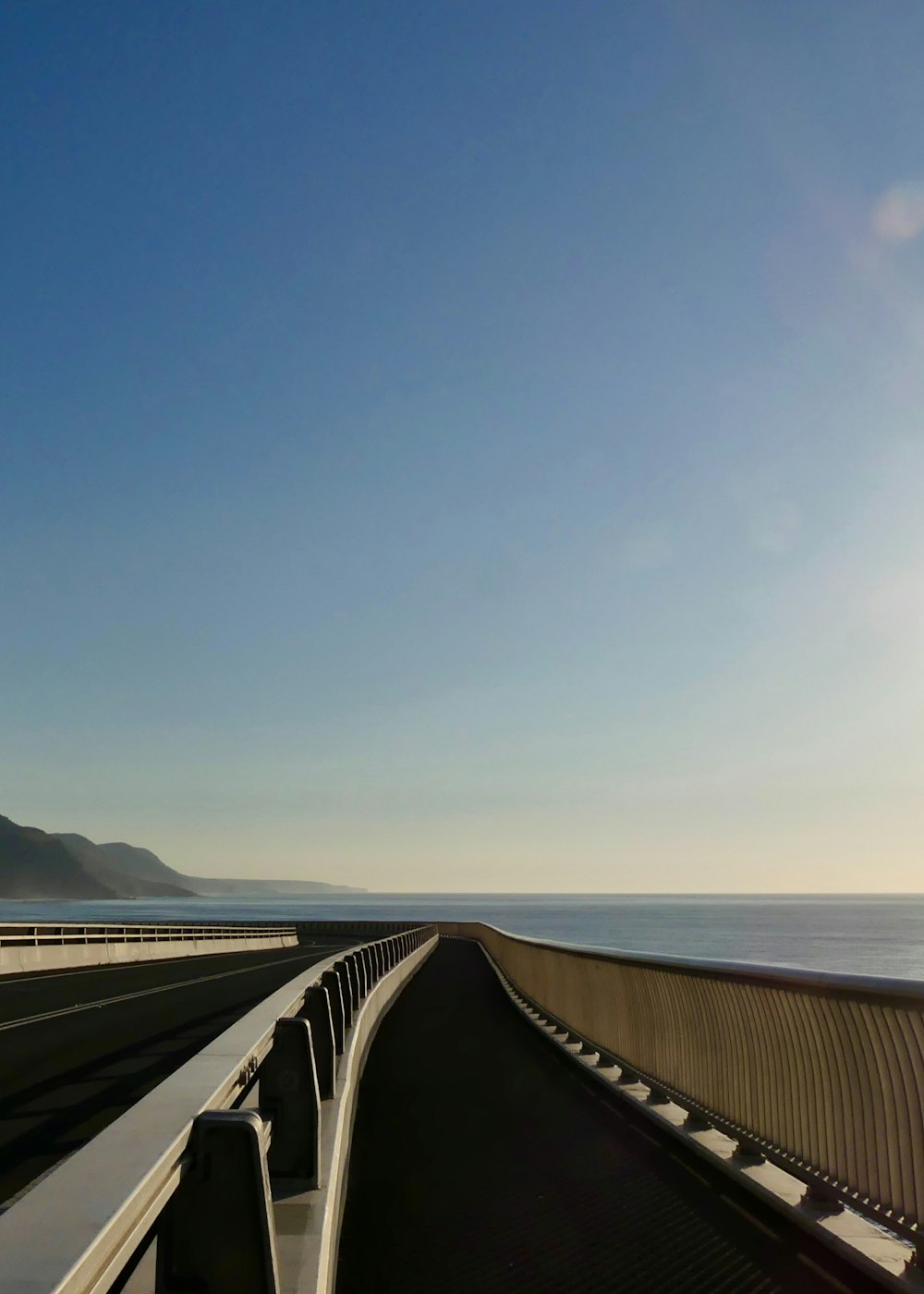 a view of the ocean from a bridge