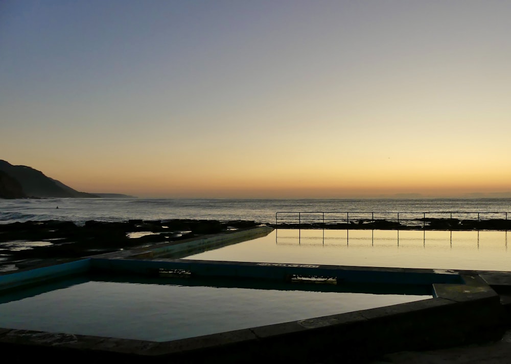 a swimming pool with a view of the ocean