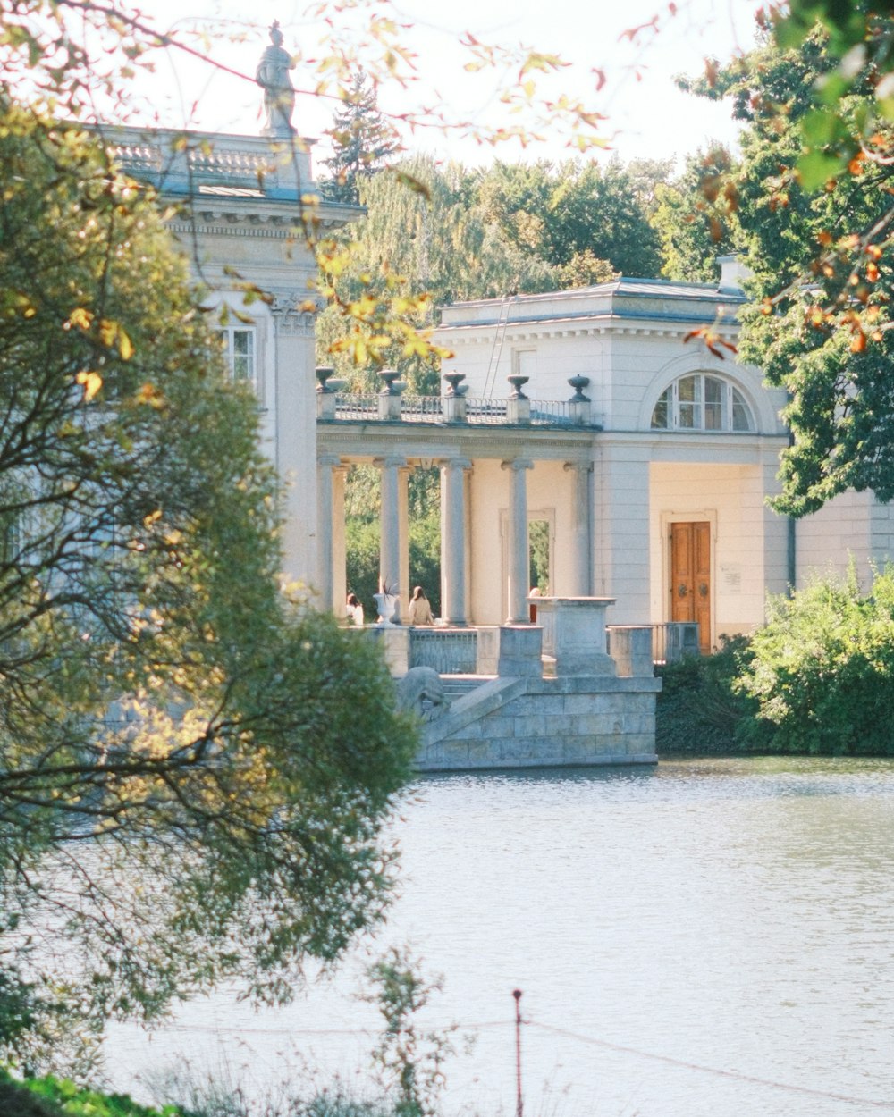 a large white building sitting next to a body of water