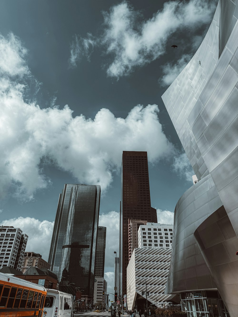 a city street with tall buildings and a bus