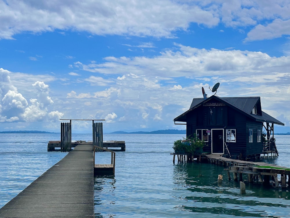 a boat dock with a house on the water