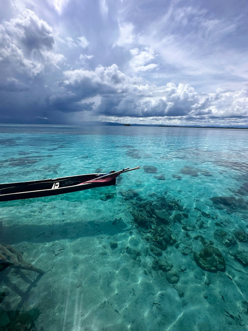 a boat floating on top of a body of water