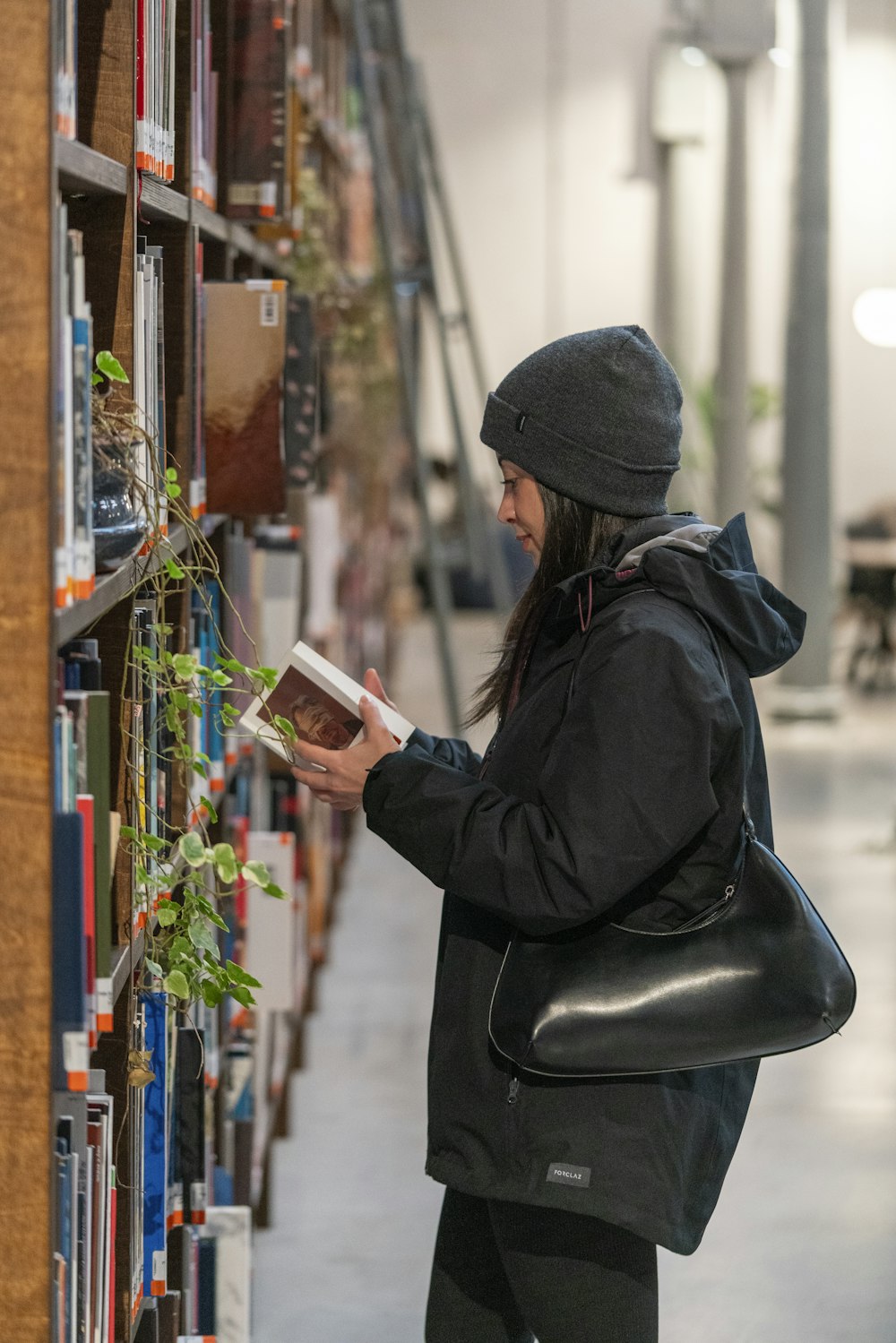 a woman reading a book in a library