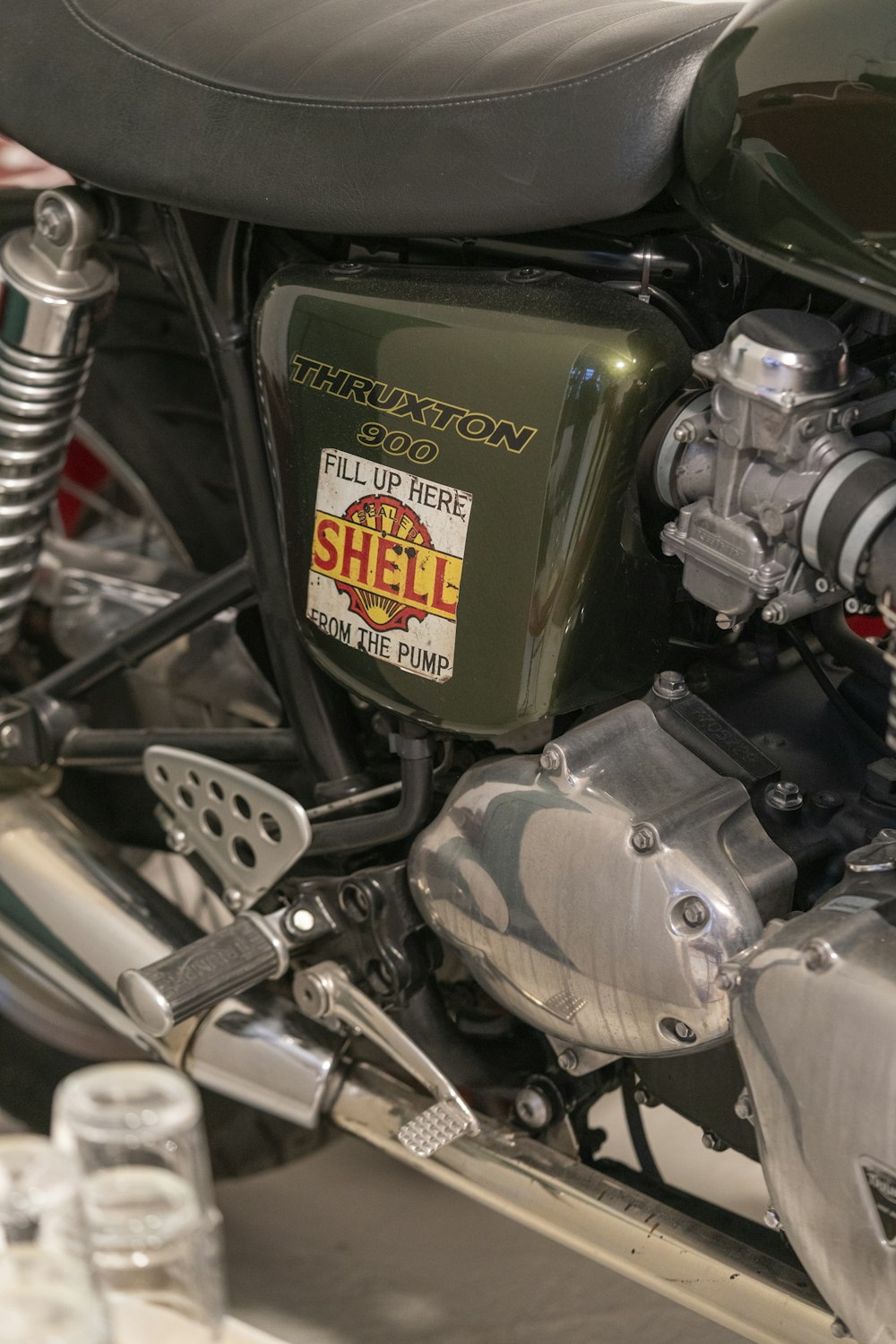 a close up of a motorcycle with a water bottle