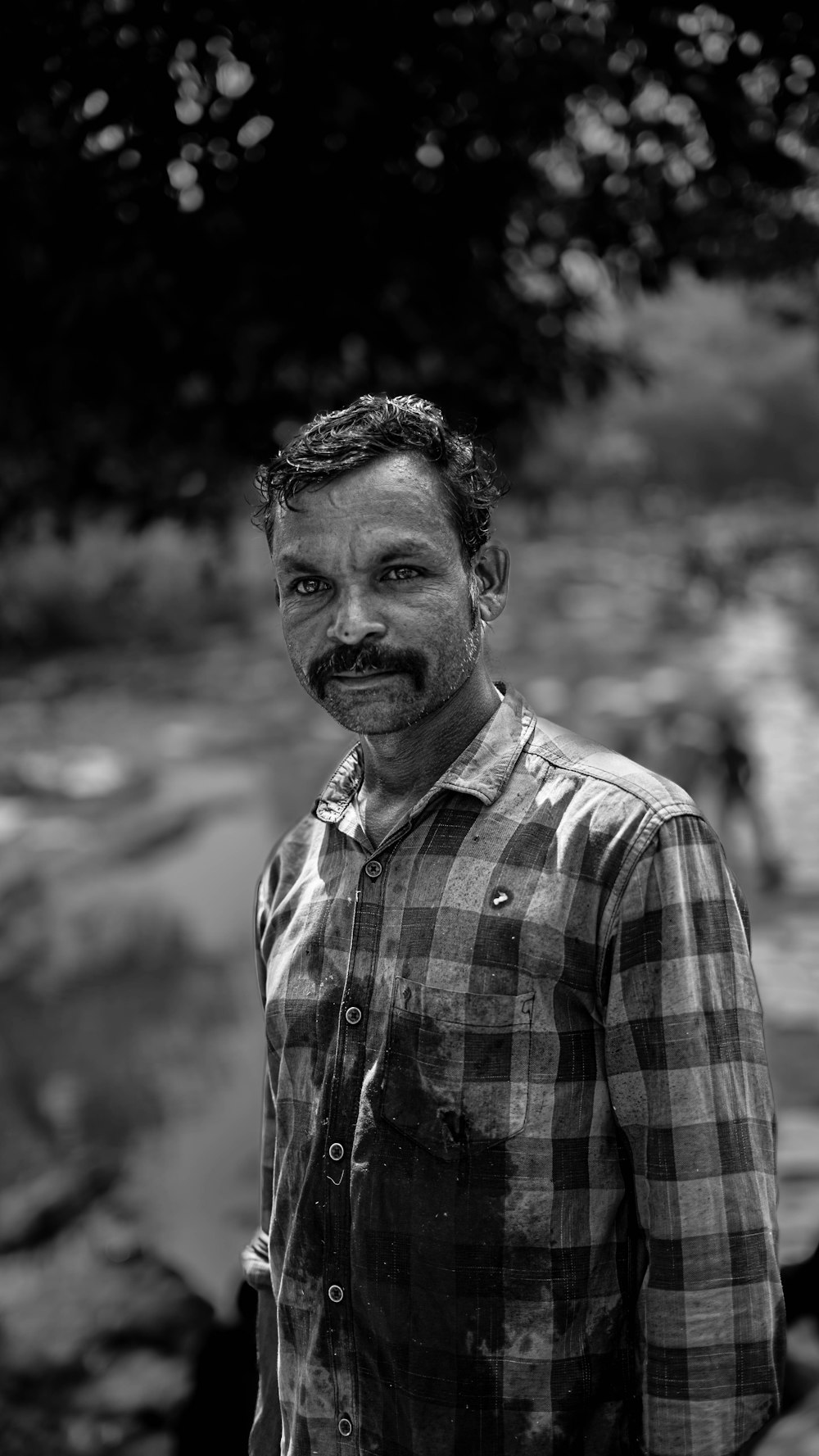 a black and white photo of a man with a mustache