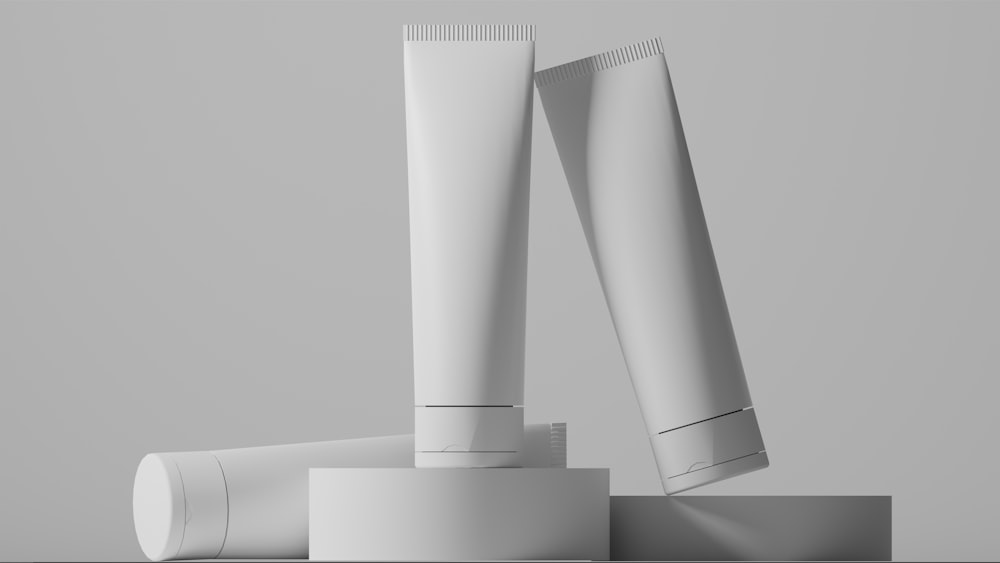 a pair of white toothbrushes sitting on top of a table