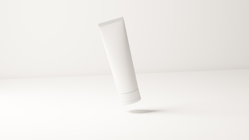 a tube of toothpaste on a white surface