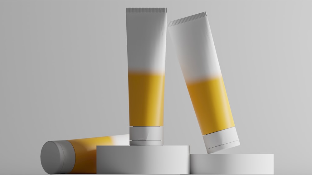 a pair of yellow and white tubes sitting on top of each other