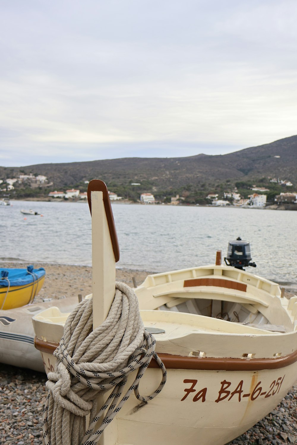 a small boat on the shore of a lake