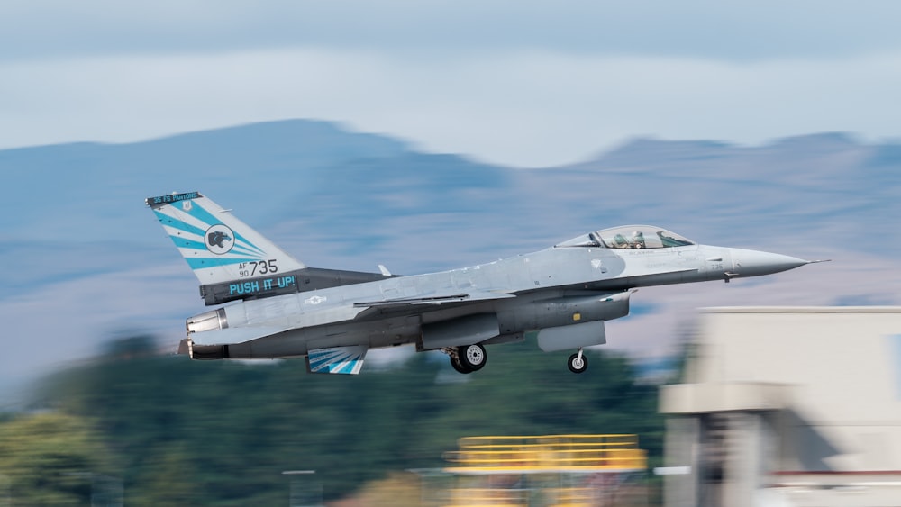 a fighter jet taking off from an airport runway