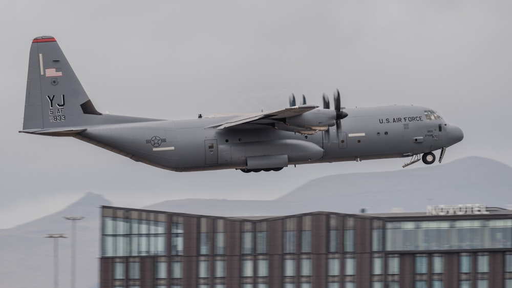 a large air plane flying over a building