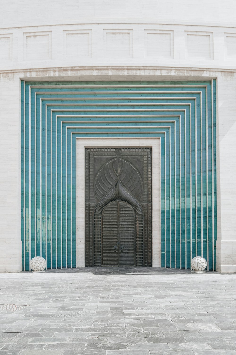 a building with a large door and a clock on the side of it