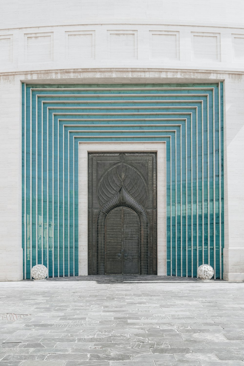 un edificio con una gran puerta y un reloj a un lado