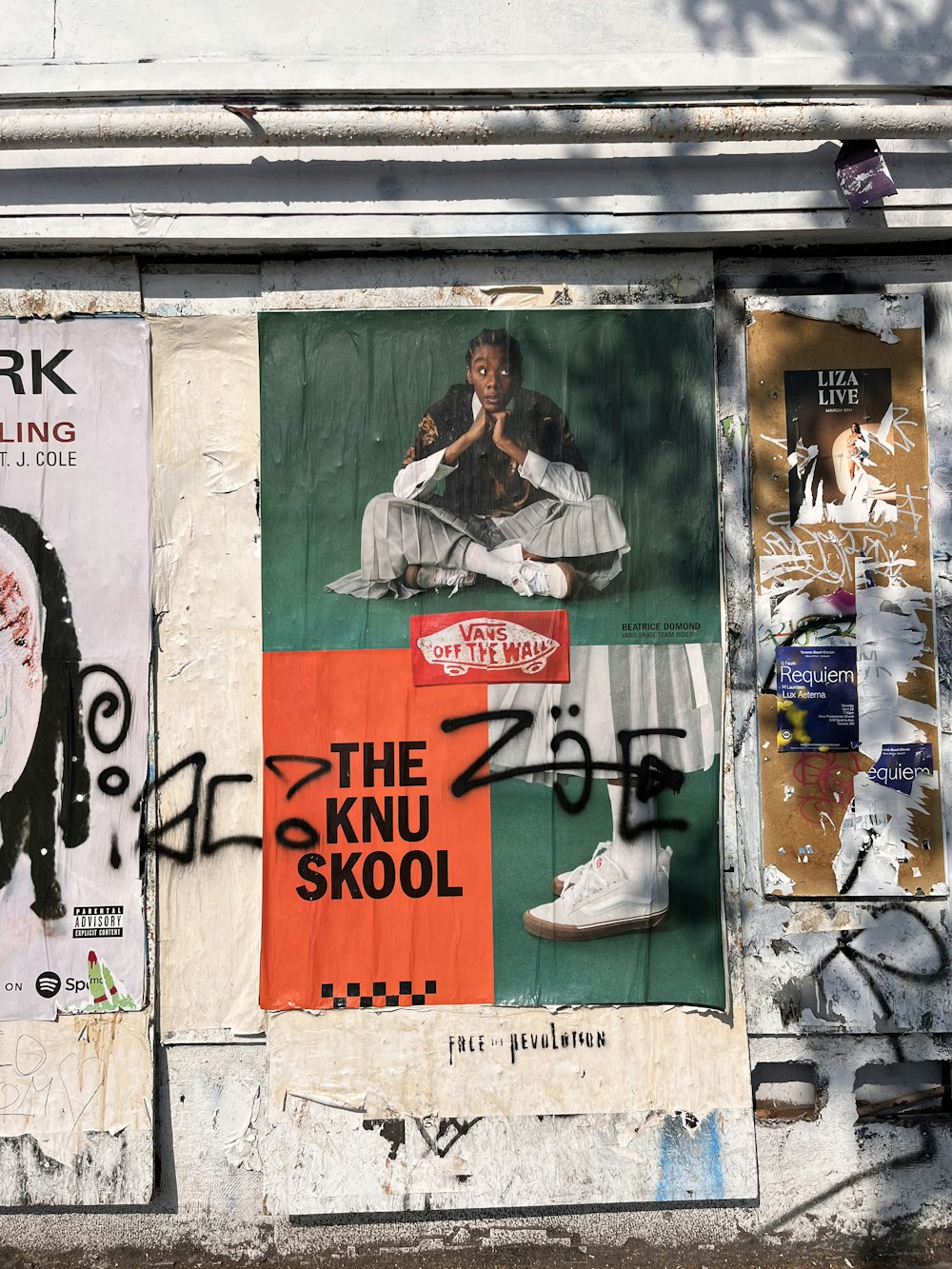 a bunch of posters on the side of a building