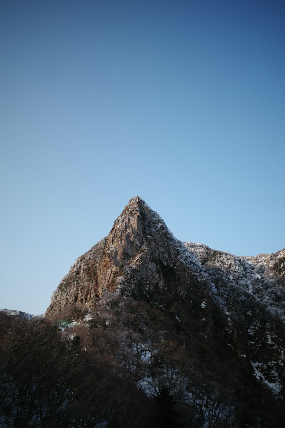 a mountain with a snow covered peak in the distance