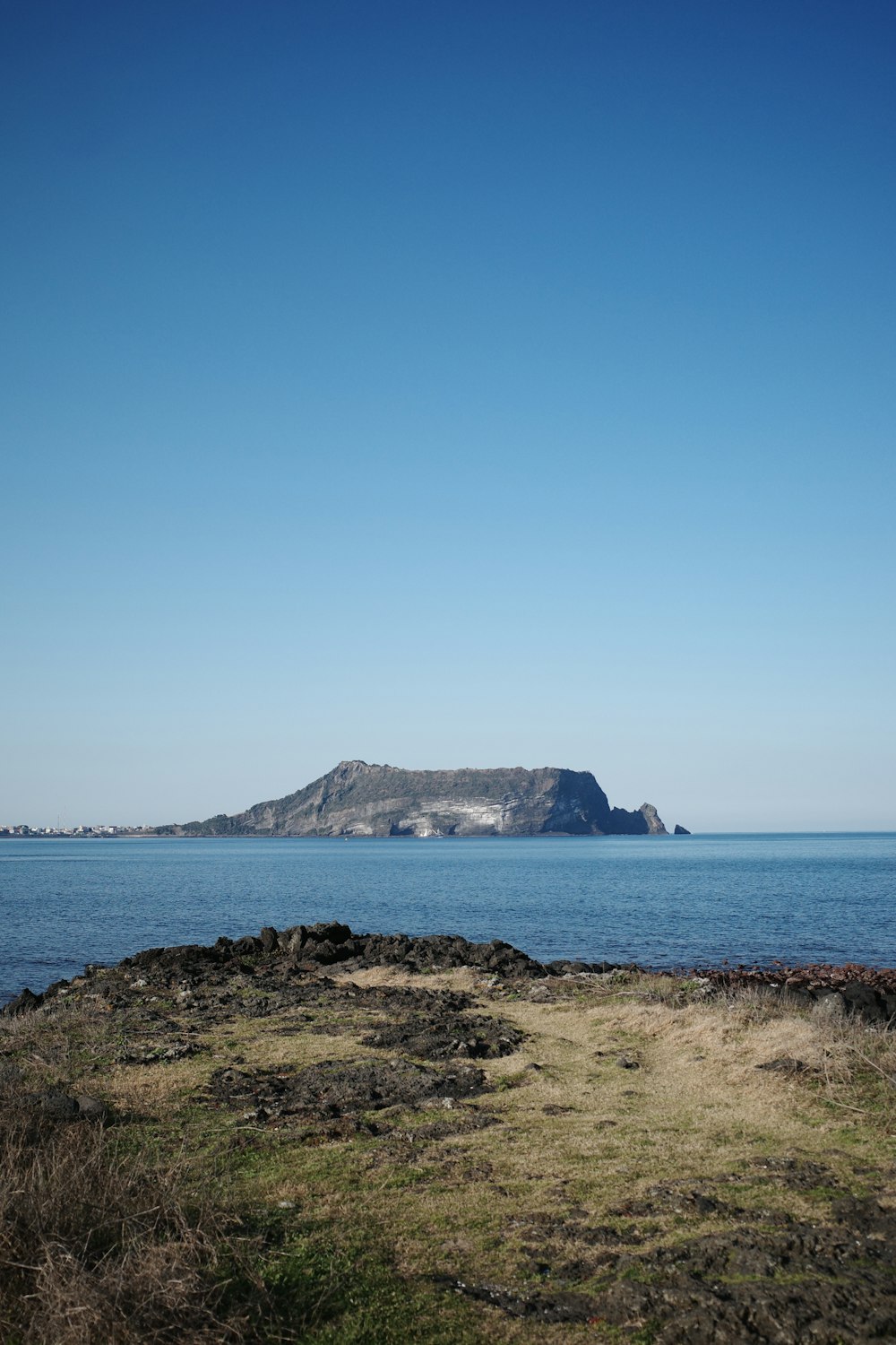 a large body of water with a small island in the distance