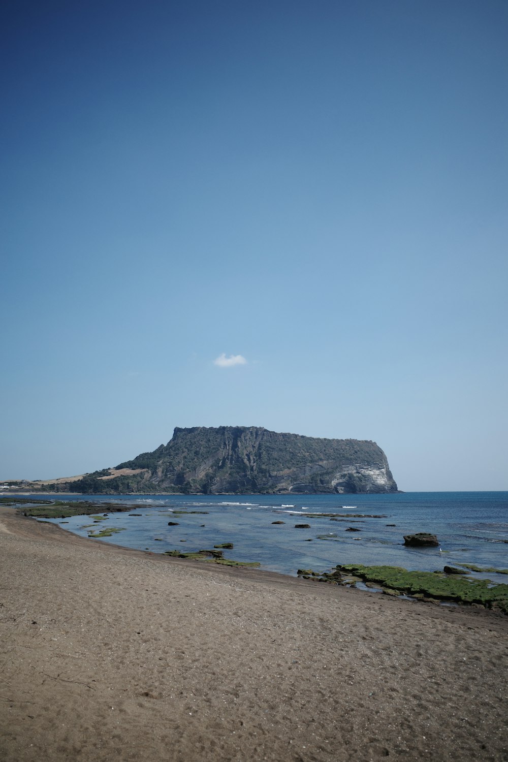 a beach with a mountain in the background